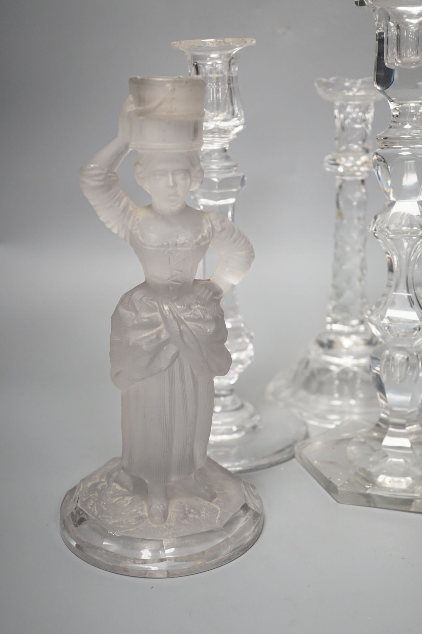 Five various cut glass candlesticks, a pair of John Ford, Holyrood Glass Works, Edinburgh figural frosted glass candlesticks and a lustre drop bag chandelier